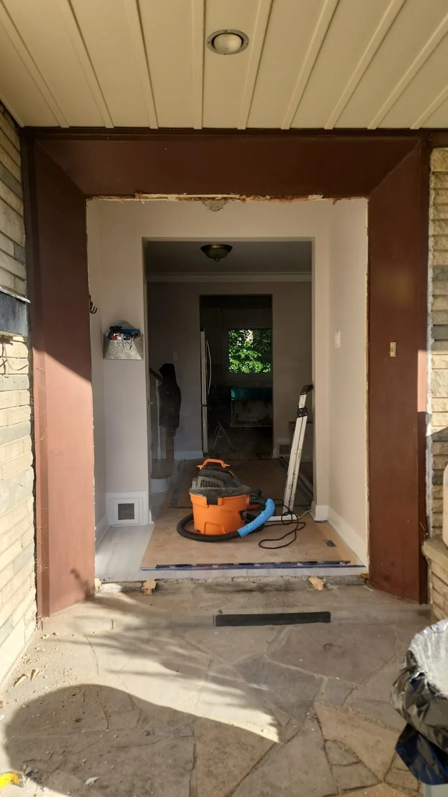 Before: Front entrance with the old door removed and the opening stripped back, ready for the new door